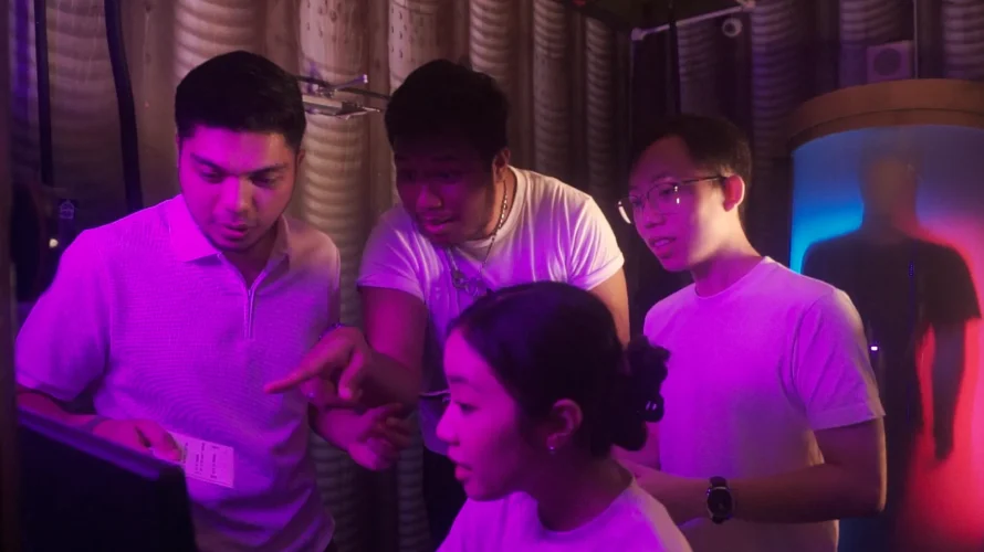 Group of players working together to solve puzzle at Breakout Escape Room